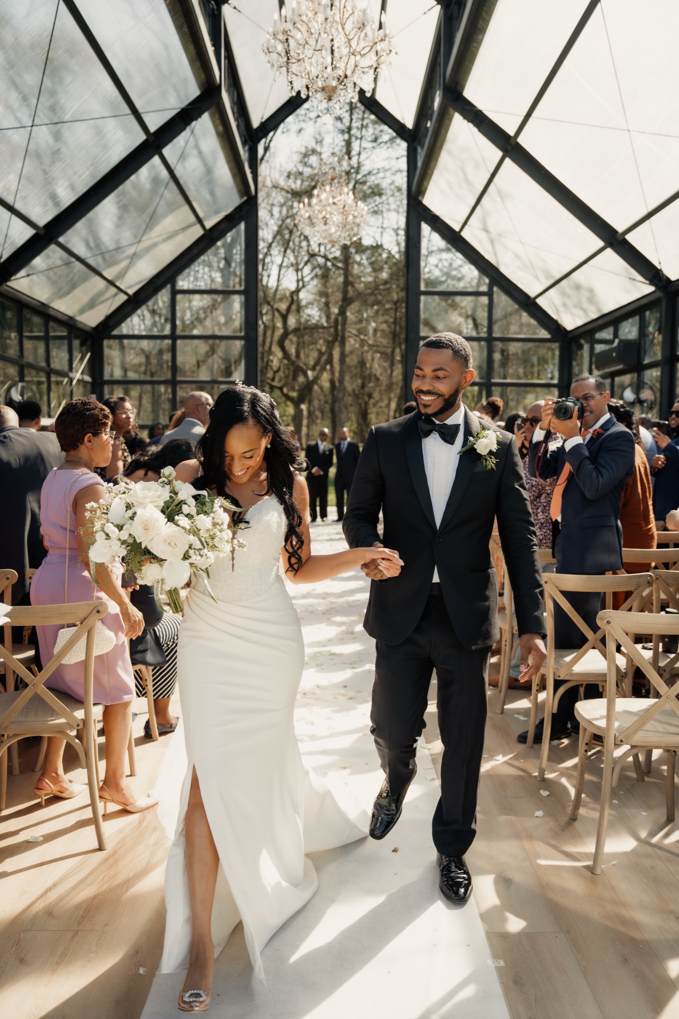 Bride and groom in a sunlit glasshouse ceremony